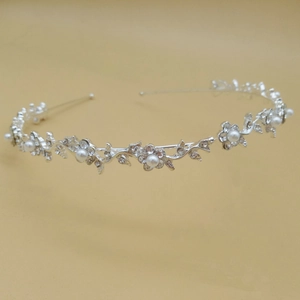Detail of silver bridal crown featuring delicate alloy vines, white pearls and crystal rhinestones