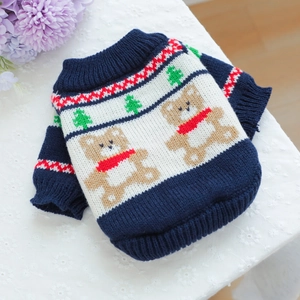 Close-up of knit pet sweater with navy bear and Christmas tree patterns on lace