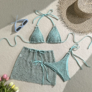 Three-piece turquoise sequin bikini set with matching sarong wrap and halter top