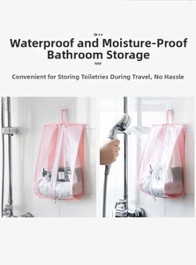 Waterproof pink hanging storage bag for toiletries with shower spray demonstration