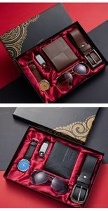 Close-up of men's business gift sets including watch, belt, wallet, and sunglasses in a box