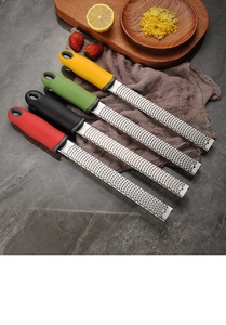 Kitchen scene with four colorful stainless steel hand-held cheese and lemon graters