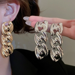 Detail view of bold metallic chain earrings in gold and silver finish for women