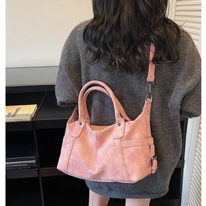 Pink large capacity faux leather tote bag for travel shown as a stylish crossbody bag