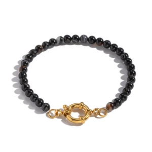 Detailed view of striped agate beads bracelet with a polished gold spring clasp