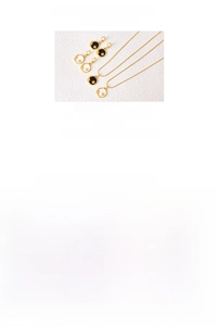Detailed close-up of titanium celestial necklaces and earrings with star moon patterns