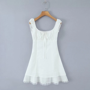 Detailed view of white mini dress featuring retro square neck and delicate lace hem edges
