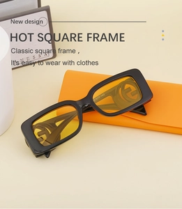 Detail of square black frame sunglasses with yellow lenses and orange leather pouch