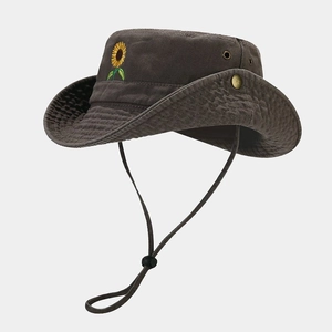 Detail of sunflower embroidery and metal eyelets on cotton outdoor fisherman hat