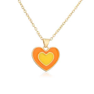 Detail of 18K gold plated heart pendant with orange and yellow enamel on O-chain