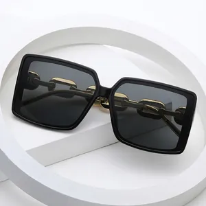 Fashion oversized square sunglasses with black frames and gold chunky chain temples
