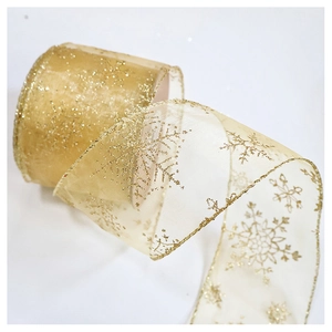 Detail of golden snowflake organza ribbon with sparkling glitter for Christmas decor