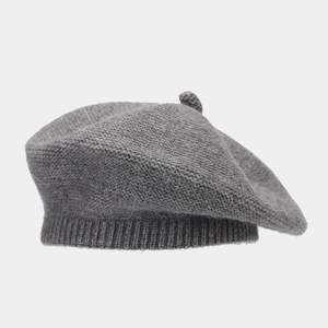 Close-up of the grey knitted beret texture and soft faux rabbit fur fabric detail