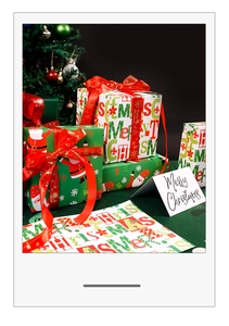 Close-up of festive red and green Merry Christmas gift wrapping paper with ribbons