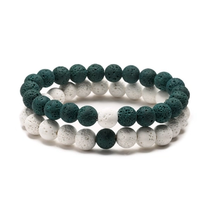 Close-up of lava rock beaded bracelets in white and teal with porous texture