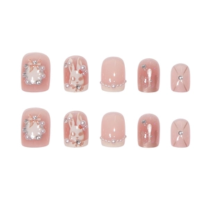 Pink press-on nail set with 3D bunny designs, pearls, bows, and sparkling rhinestones