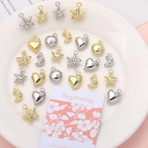 Macro shot of mini rhinestone heart star moon alloy charms for DIY jewelry making