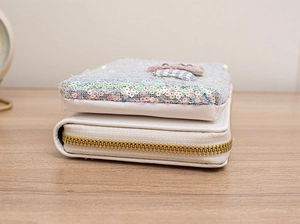 Detail shot of sequin handbag showing high-quality gold zipper and fabric texture