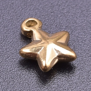 Close-up of golden star-shaped jewelry pendant with polished 18k gold plating finish