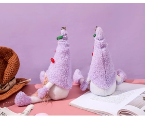Detail of purple Christmas gnomes with plush hats, strawberry decor and long legs