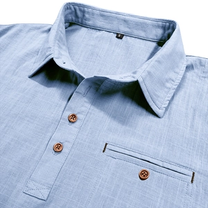 Detailed macro view of light blue linen shirt collar with natural wood button and pocket