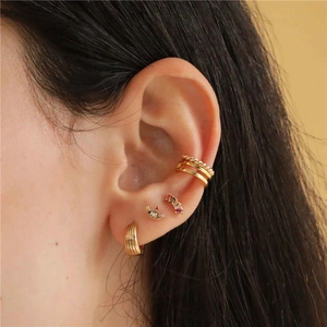 Close-up of gold-plated S925 silver helix ear cuff and cartilage stud with colorful gems