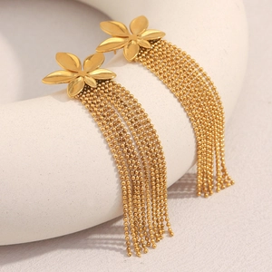 Detailed view of 18K gold flower earrings with elegant hanging metal bead chain tassels