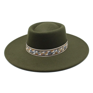 Detail of dark green wool felt fedora featuring a colorful ethnic geometric woven hat band
