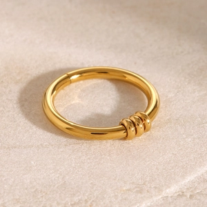 Macro shot of 18k gold plated stainless steel nose ring with three small sliding beads
