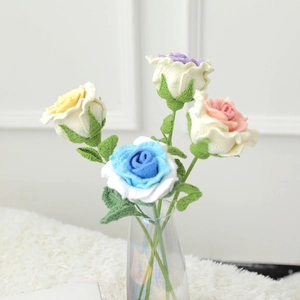 Handmade crochet rose bouquet in glass vase with multi-color petals and green stems