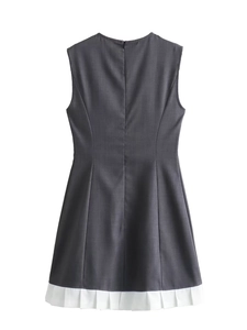 Detail view of the back of a sleeveless high waist dress with white pleated hemline