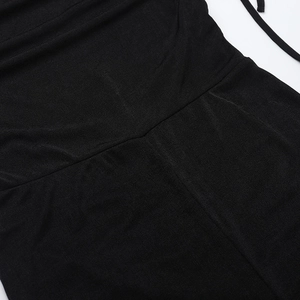 Close-up of the black knitted fabric showing fine stitching and smooth texture