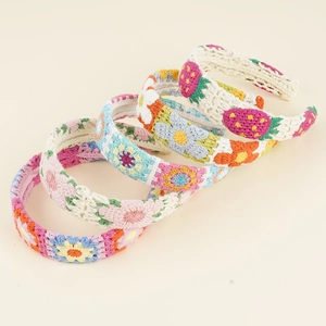 Detailed knit headbands with floral crochet patterns in four vibrant seasonal colors