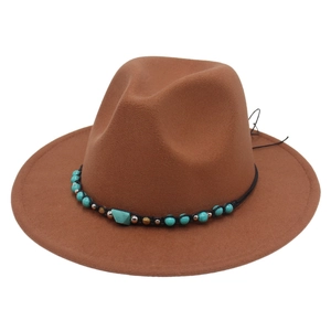 Close-up of brown felt cowboy hat with turquoise beads and black braided ethnic band