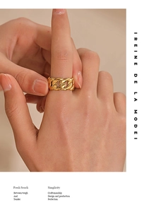 Detail of adjustable gold Cuban chain link ring on model hand for minimalist style