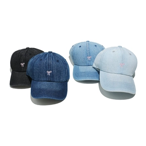 Detailed embroidery of pink bows on denim baseball caps in four assorted blue shades