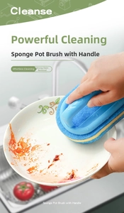 Close-up of cleaning a dirty ceramic plate with an ergonomic handle sponge pot brush
