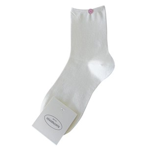 White ribbed crew socks with brand tag, soft cotton texture for a minimalist style