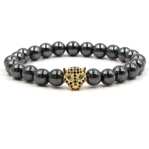 Detail of vintage beaded bracelet with black hematite stones and golden leopard head