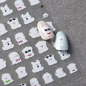 Detailed sheet of cute 5D puppy nail art stickers featuring white fluffy bichon motifs