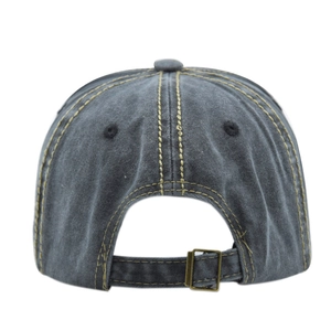 Detail of adjustable metal buckle and contrast stitching on vintage cotton baseball cap