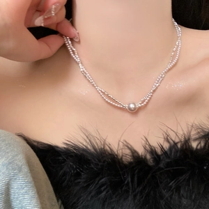 Elegant silver double-layer pearl necklace with single pendant on a female model