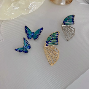 Detail of blue enamel butterfly brooches with intricate hollowed-out gold and silver plating