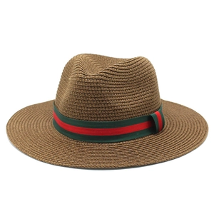 Détail d'un chapeau Panama en paille marron avec ruban rayé rouge et vert style classique