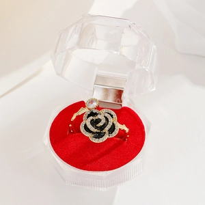 Detail of 18K gold ring with black rose motif and pave zircon crystals in a box