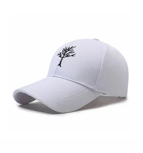 Detail view of the black tree embroidery on a white cotton baseball cap with curved brim