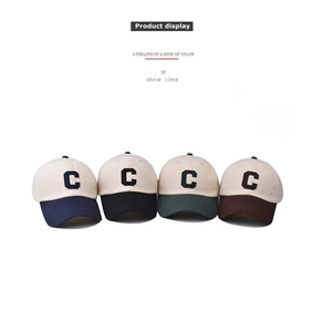 Detail of four-color washed cotton baseball caps with embroidered C patch and vintage style