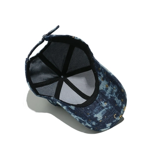 Detail view showing inner structure and gold star moon embroidery on denim baseball cap