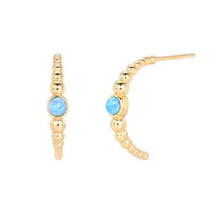 Macro detail of S925 silver gold-plated C-shaped earring with blue opal stone