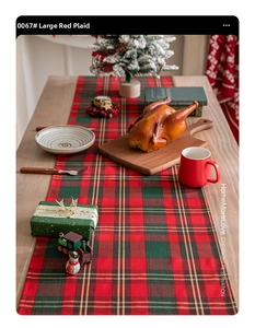 Detailed red and green plaid Christmas table runner on a wooden festive dining setup